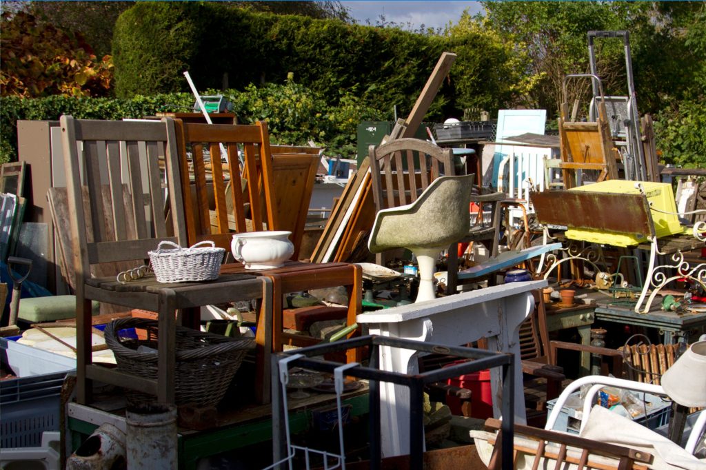Furniture and household items gathered outside during a cleanout